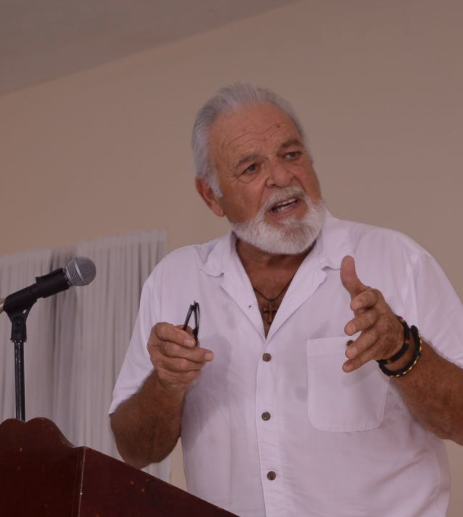Rev. Terry A. Christian speaking in a white shirt